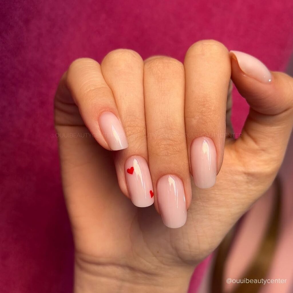 Nude Nails with Red Hearts Detail