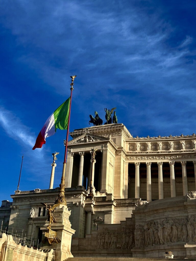 Vittorio Emanuele II Monument and italan flag at sundown